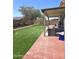 Enjoy a spacious backyard, patio, and artificial grass, perfect for outdoor living at 15023 W Redfield Rd, Surprise, AZ 85379