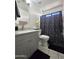 This bright bathroom boasts a vanity and a shower with modern features at 15023 W Redfield Rd, Surprise, AZ 85379