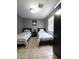 Bedroom featuring tile floors, two twin beds, and a black wardrobe at 15023 W Redfield Rd, Surprise, AZ 85379