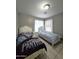 Bright bedroom with tile floors, two twin beds and a neutral color palette at 15023 W Redfield Rd, Surprise, AZ 85379