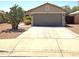 Charming single-story home featuring a two-car garage and desert landscaping at 15023 W Redfield Rd, Surprise, AZ 85379