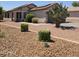 Charming single-story home featuring desert landscaping and a covered entry at 15023 W Redfield Rd, Surprise, AZ 85379