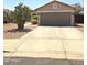 Charming single-story home featuring a two-car garage and desert landscaping at 15023 W Redfield Rd, Surprise, AZ 85379