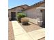Inviting covered front porch with decorative stone columns and desert landscaping at 15023 W Redfield Rd, Surprise, AZ 85379