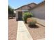 Inviting covered front porch with decorative stone columns and desert landscaping at 15023 W Redfield Rd, Surprise, AZ 85379