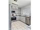 Bright kitchen with stainless steel appliances, granite counters, and gray cabinetry at 15023 W Redfield Rd, Surprise, AZ 85379