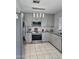 Modern kitchen with stainless steel appliances, granite counters, and gray cabinets at 15023 W Redfield Rd, Surprise, AZ 85379