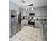 Bright kitchen featuring stainless steel appliances, granite counters, and modern gray cabinetry at 15023 W Redfield Rd, Surprise, AZ 85379