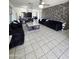 Large living room features decorative wall, tile floor, modern furniture and decor at 15023 W Redfield Rd, Surprise, AZ 85379