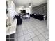 Spacious living room with tile floors, modern decor, and statement lighting at 15023 W Redfield Rd, Surprise, AZ 85379