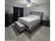 Spacious main bedroom with a ceiling fan, a large bed and a cushioned bench at 15023 W Redfield Rd, Surprise, AZ 85379