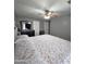 Relaxing bedroom featuring a ceiling fan, comfy bed, and neutral color palette at 15023 W Redfield Rd, Surprise, AZ 85379