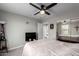 Cozy bedroom featuring a ceiling fan, carpet floors, and access to an ensuite bathroom at 15028 W Minnezona Ave, Goodyear, AZ 85395