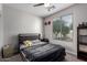 Bright bedroom featuring a ceiling fan, window, neutral walls, and a comfortable bed with stylish bedding at 15028 W Minnezona Ave, Goodyear, AZ 85395