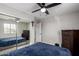 This bedroom features a closet with sliding mirror doors and neutral colored walls at 15028 W Minnezona Ave, Goodyear, AZ 85395