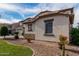 Charming home featuring a landscaped front yard and stylish stone accents at 15028 W Minnezona Ave, Goodyear, AZ 85395