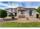 Charming two-story home featuring a landscaped front yard and stylish stone accents and lovely desert landscaping at 15028 W Minnezona Ave, Goodyear, AZ 85395