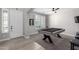 A well-lit game room features a stylish pool table, perfect for entertaining at 15028 W Minnezona Ave, Goodyear, AZ 85395
