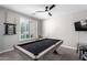 Inviting game room with a pool table and ceiling fan, ideal for leisure at 15028 W Minnezona Ave, Goodyear, AZ 85395
