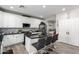 Open kitchen design with white cabinets, black granite countertops, a central island, and stainless appliances at 15028 W Minnezona Ave, Goodyear, AZ 85395