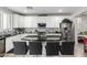 Well-equipped kitchen with white cabinets, granite counters, stainless steel appliances, and stylish backsplash at 15028 W Minnezona Ave, Goodyear, AZ 85395