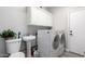 Functional laundry room featuring modern appliances, built-in storage, and a convenient sink at 15028 W Minnezona Ave, Goodyear, AZ 85395
