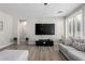 Cozy living room featuring a large TV and comfortable seating area at 15028 W Minnezona Ave, Goodyear, AZ 85395