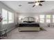 Comfortable primary bedroom featuring neutral tones, large windows, ceiling fan, and an inviting ambiance at 15028 W Minnezona Ave, Goodyear, AZ 85395