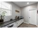 Functional mud room area with built-in cabinets, countertop space, and a convenient laundry area at 15028 W Minnezona Ave, Goodyear, AZ 85395