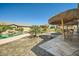 Inviting backyard featuring a sparkling pool, palapas, and lush landscaping at 15211 N 184Th Ct, Surprise, AZ 85388