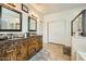 Bathroom featuring double vanity with granite countertop, decorative mirrors, and white cabinets at 15211 N 184Th Ct, Surprise, AZ 85388