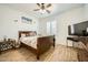Bedroom with warm-toned walls, decorative bedding, and a ceiling fan for added comfort at 15211 N 184Th Ct, Surprise, AZ 85388