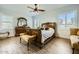 Charming bedroom featuring traditional furniture, ceiling fan, shuttered windows, and light-colored walls at 15211 N 184Th Ct, Surprise, AZ 85388