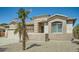 Close up of tan home featuring desert landscaping and an arched window with white blinds at 15211 N 184Th Ct, Surprise, AZ 85388