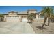 Tan home featuring a three car garage, desert landscaping, and palm trees at 15211 N 184Th Ct, Surprise, AZ 85388