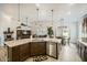 Open concept kitchen featuring granite countertops, stainless steel appliances and adjacent dining area at 15211 N 184Th Ct, Surprise, AZ 85388