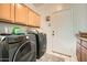 Convenient laundry room with modern washer and dryer and functional storage cabinets at 15211 N 184Th Ct, Surprise, AZ 85388