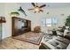 Living room showcasing a large entertainment center, wood floors, and leather sofa at 15211 N 184Th Ct, Surprise, AZ 85388