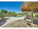 Relaxing pool area with a tiki bar and lush surroundings for ultimate outdoor enjoyment at 15211 N 184Th Ct, Surprise, AZ 85388