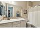 Neutral toned bathroom featuring a single sink, mosaic tile backsplash and shower/tub combination at 15849 W Alvarado Dr, Goodyear, AZ 85395