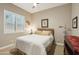 Cozy bedroom with shuttered window, neutral walls, and soft lighting creating a relaxing atmosphere at 15849 W Alvarado Dr, Goodyear, AZ 85395