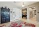 Welcoming foyer features neutral tile flooring, black hutch and view into office area at 15849 W Alvarado Dr, Goodyear, AZ 85395