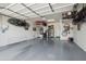 Spacious garage with epoxy flooring offering secure parking, storage racks, and ample room for hobbies and projects at 15849 W Alvarado Dr, Goodyear, AZ 85395