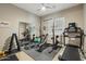 Home gym featuring a treadmill, free weights, and weight training equipment, ideal for fitness enthusiasts at 15849 W Alvarado Dr, Goodyear, AZ 85395