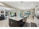 Expansive kitchen island with a sink and dishwasher that opens up to the inviting living space at 15849 W Alvarado Dr, Goodyear, AZ 85395
