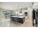 Bright kitchen with white cabinets, stainless steel appliances, a dark island, and a casual dining area at 15849 W Alvarado Dr, Goodyear, AZ 85395
