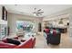 Well-lit living room featuring stylish seating arrangements and a seamless transition to an outdoor patio area at 15849 W Alvarado Dr, Goodyear, AZ 85395