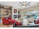Cozy living room featuring a fireplace, contemporary furniture, and seamless access to the outdoor patio area at 15849 W Alvarado Dr, Goodyear, AZ 85395
