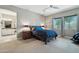Spacious main bedroom with a king-sized bed, bedside tables, a ceiling fan and an ensuite bathroom at 15849 W Alvarado Dr, Goodyear, AZ 85395