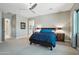 Third view of the main bedroom highlighting the neutral colors, large windows, bedside tables and ensuite access at 15849 W Alvarado Dr, Goodyear, AZ 85395
